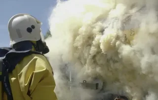 Firefighter in heavy toxic smoke.
